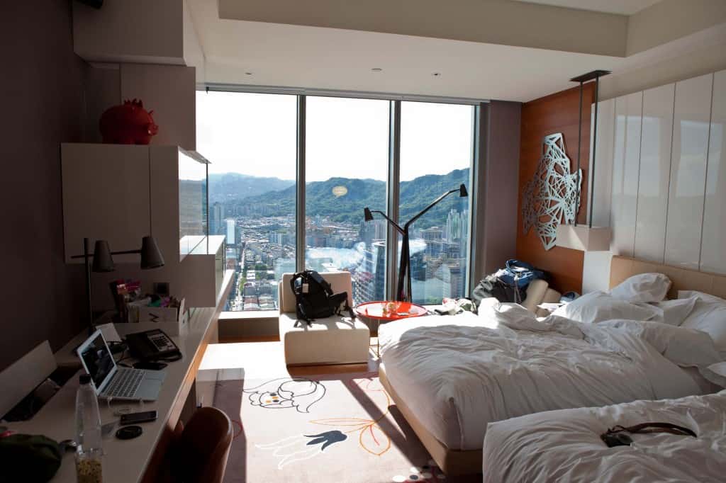 w hotel in taiwan with backpack and gear unpacked in minimalist travel tips