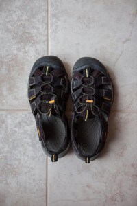 black keen newport h2 sandals on tile floor