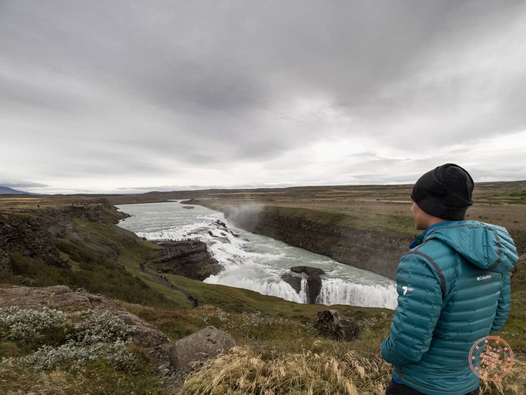 man watching gullfoss waterfall in iceland golden circle road trip