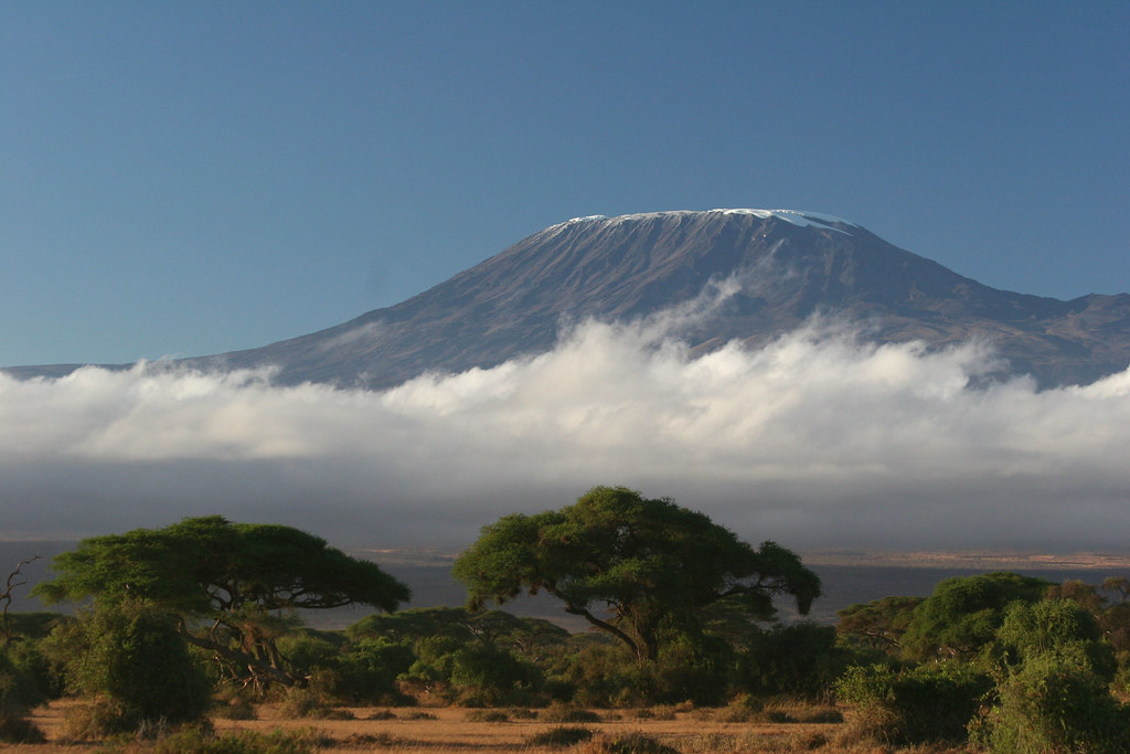 clouds below mount kilimanjaro is easily one of the most beautiful places to travel to in africa