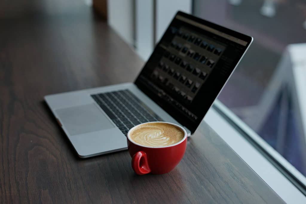 laptop and latte in a red cup when building your itinerary