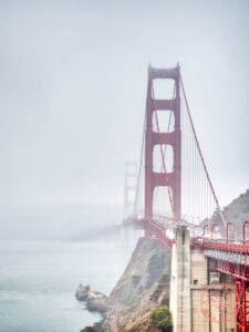 golden gate bridge surrounded by fog at viewpoint