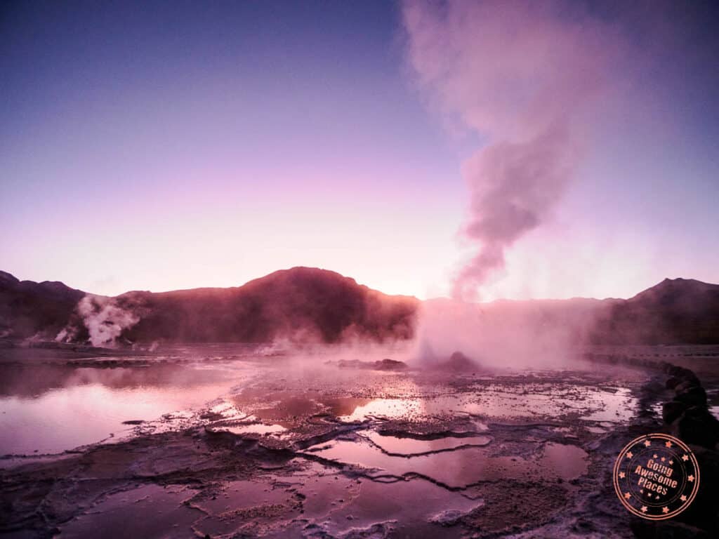 geyser del tatio at dawn with the most active great geyser