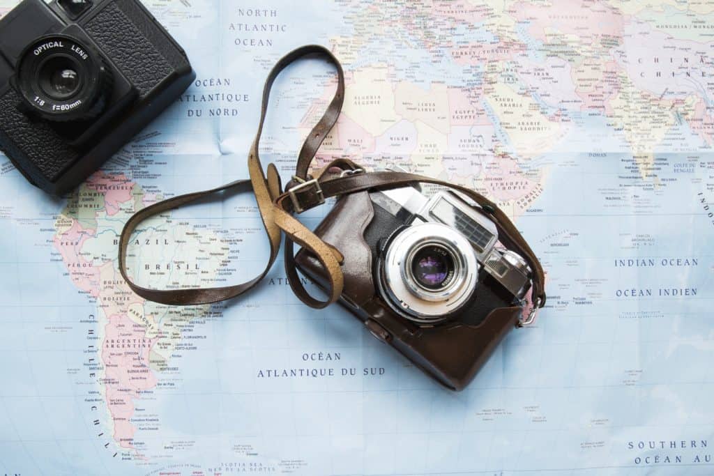 two cameras on top of a map in trip planning process