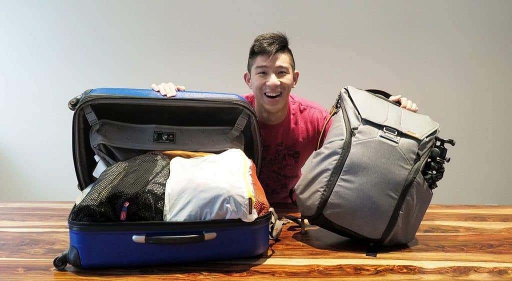 suitcase and backpack in minimalist travel packing tips