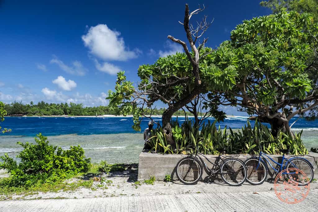two bikes parked on side of road to watch dolphin jumping at Tiputa Pass