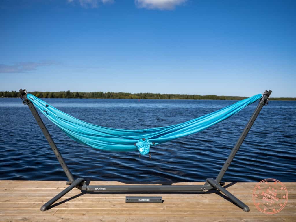 kammok swiftlet on a wooden deck with the roo single hammock attached in lounge mode