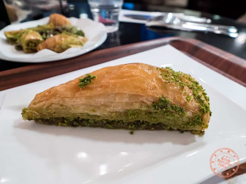 karakoy gulluoglu baklava with pistachio slice on a plate