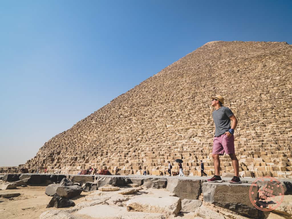 posing with buff headwear on wrist while standing in front of great pyramid