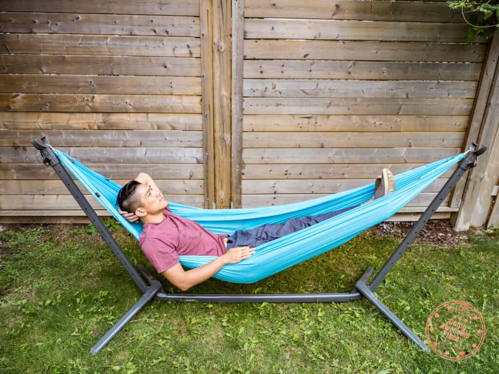man relaxing on kammok roo single attached to swiftlet in lounge mode